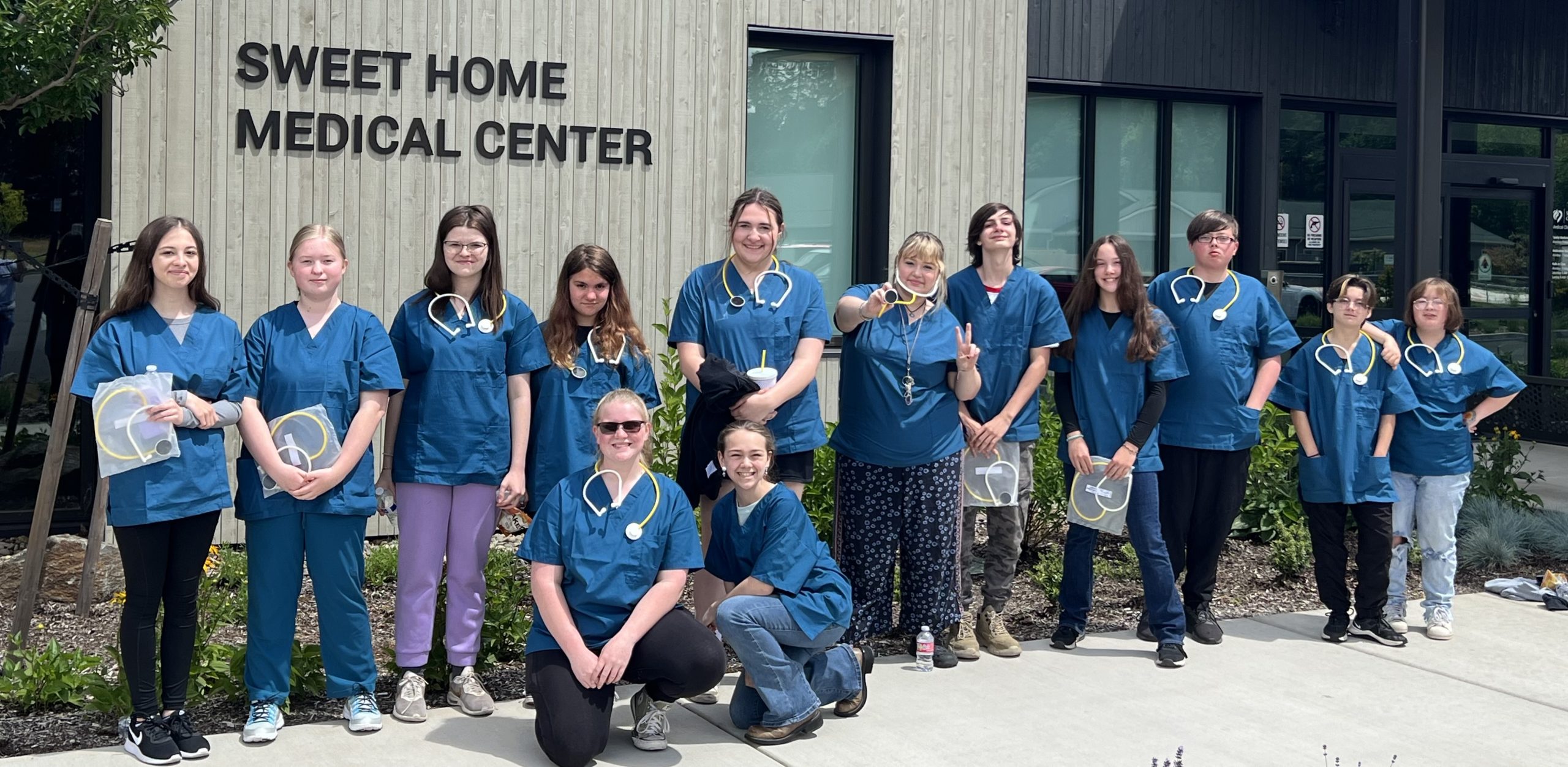Health occupation students standing in front of the Sweet Home Medical Center